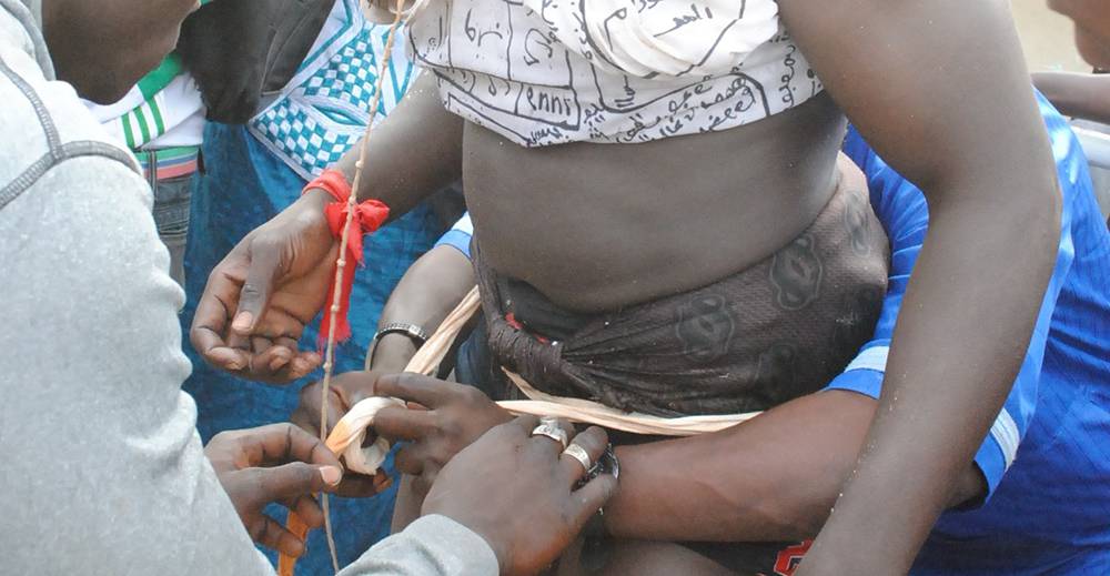 A wrestler's nguimb or loincloth is adjusted prior to fighting (Photo Mark Hann)
