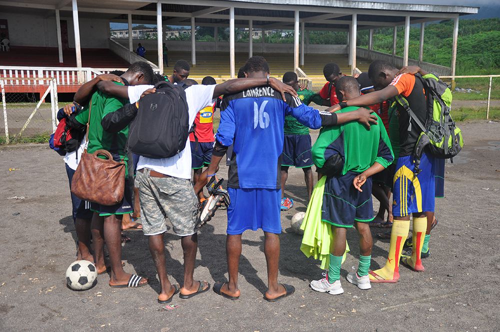 Uros Kovac - football, prayer, Buea, 2014. Every training session starts and ends with a collective prayer. An increasing number of young footballers are joining Pentecostal denominations. Buea, Cameroon, September 2014. Photo by Uroš Kovač.