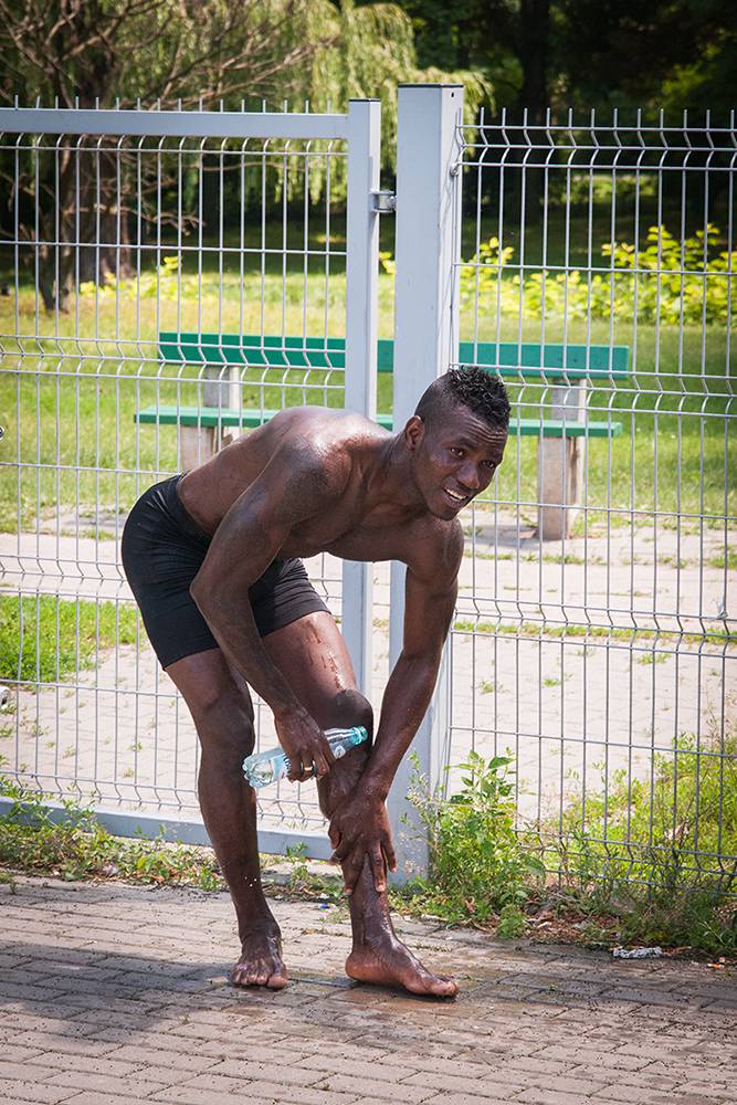A Nigerian footballer washes after the game on a hot July afternoon. Warsaw, Summer 2016. (Photo Paweł Banaś)
