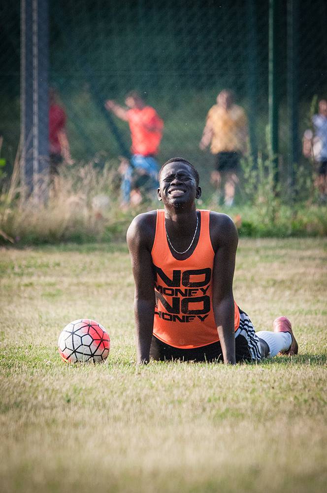 Idrissa, a young Senegalese footballer who plays for an amateur fifth division side near Kraków, in the south part of the country is stretching after an extra training session. He and a few other West African players who live in and around Kraków meet every morning for “private” two-hour long trainings with their Nigerian manager, and former football player Sunday Ibrahim. Kraków area, Summer 2016. (Photo Paweł Banaś)